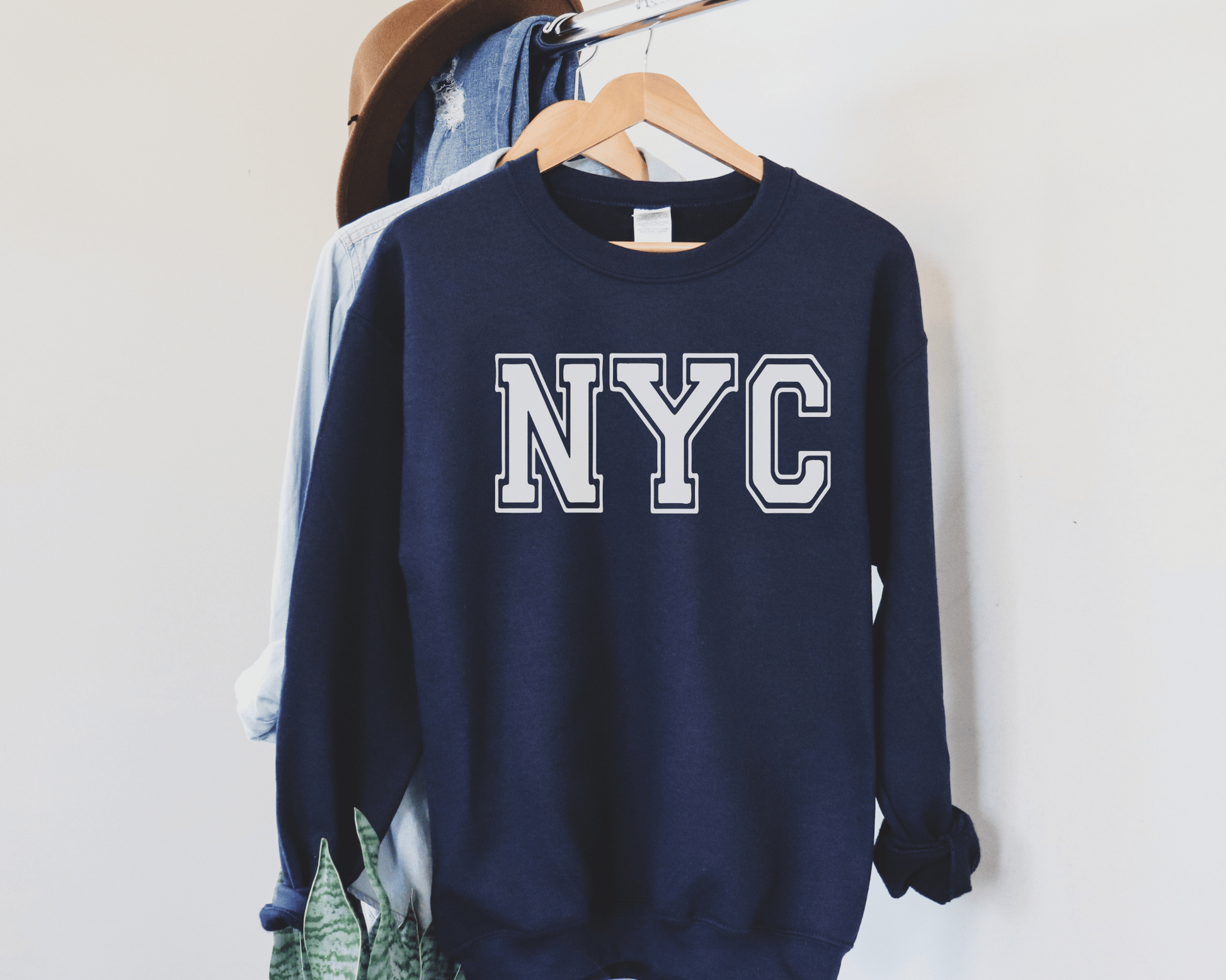 NYC Sweatshirt in Navy, hanging.