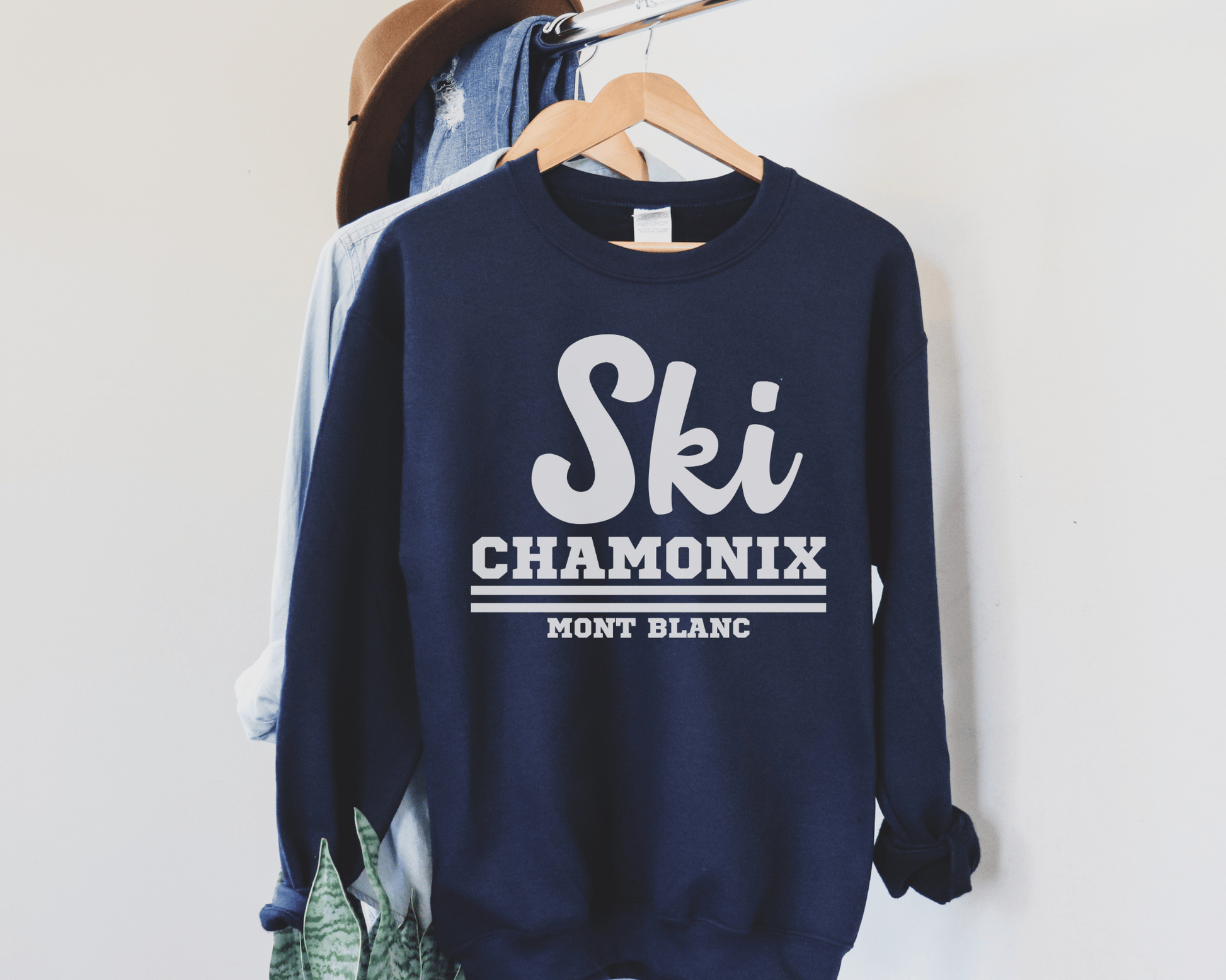 Ski Chamonix Sweatshirt in Navy on a hanger.
